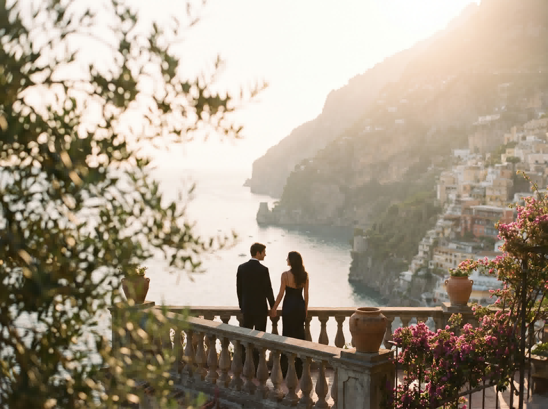 A couple at golden hour on a terrace overlooking the Amalfi coast